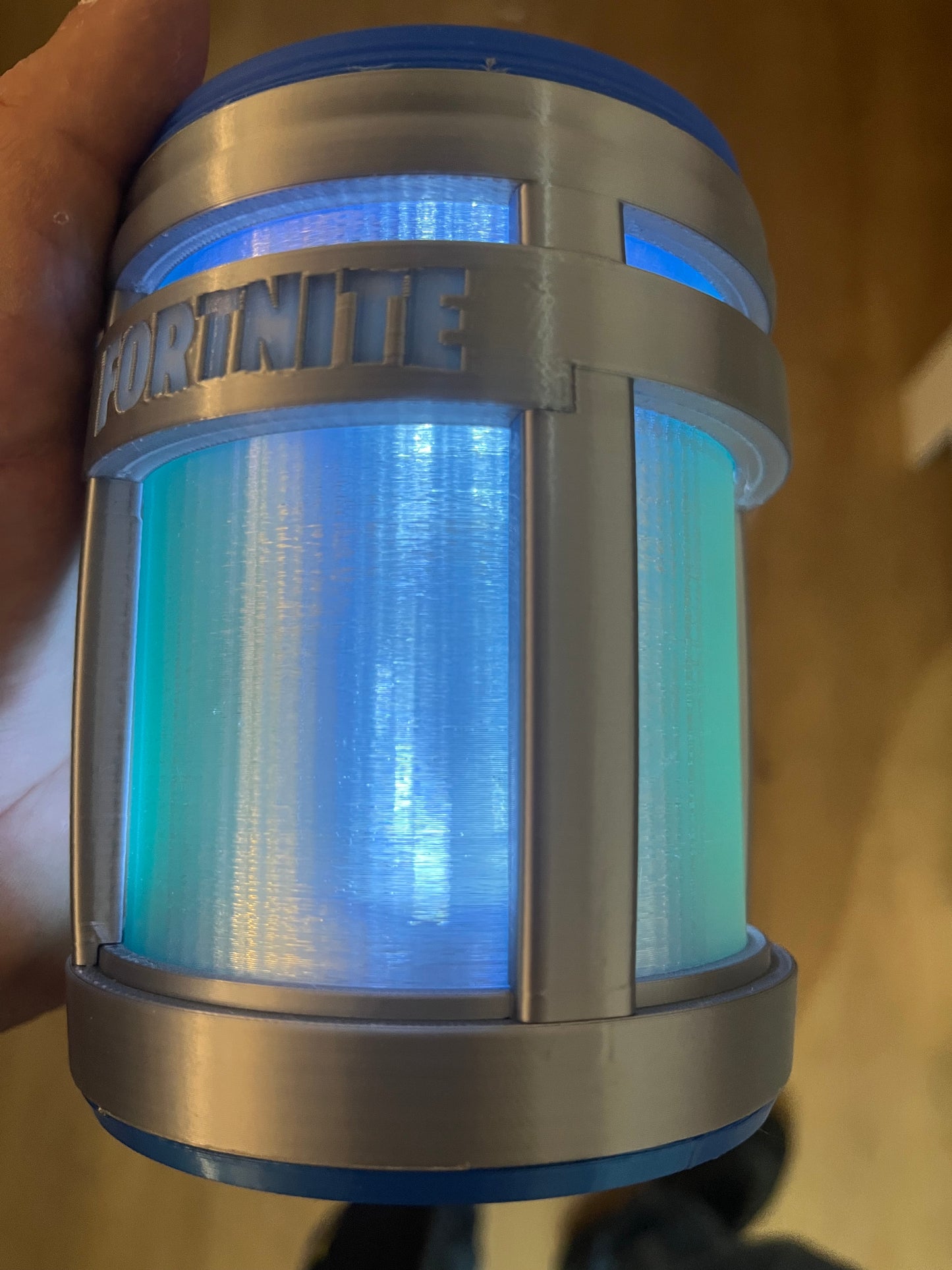 Portable light with blue light emission held in hand