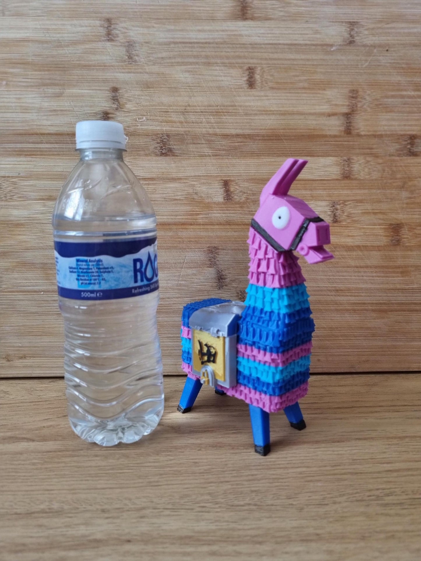 Piñata Llama Figuring. Fortnight gaming accessory with detailed gold and silver saddle bags.