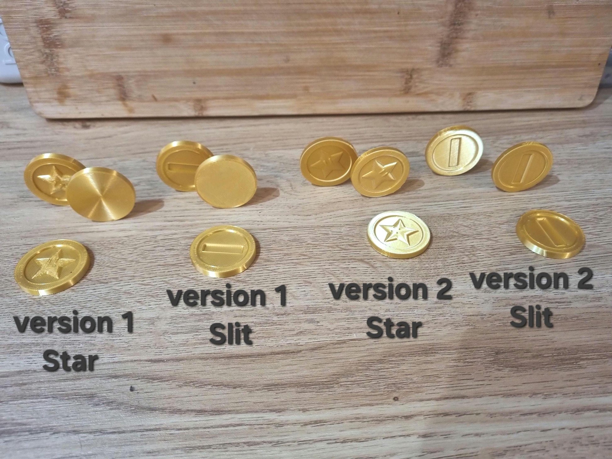 Version 1: Single Sided Chunky Coin. Version 2 : Double Sided Smooth coin.